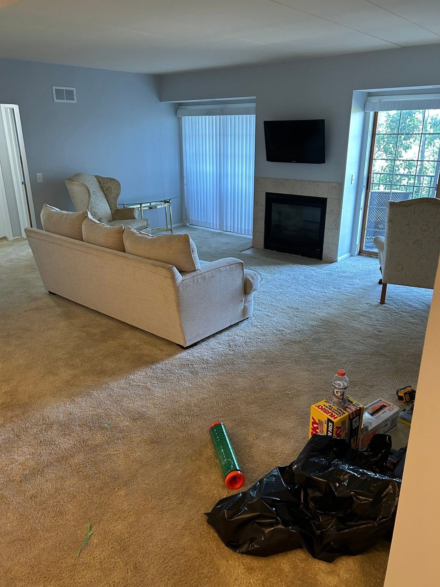Before: worn carpet in a living room