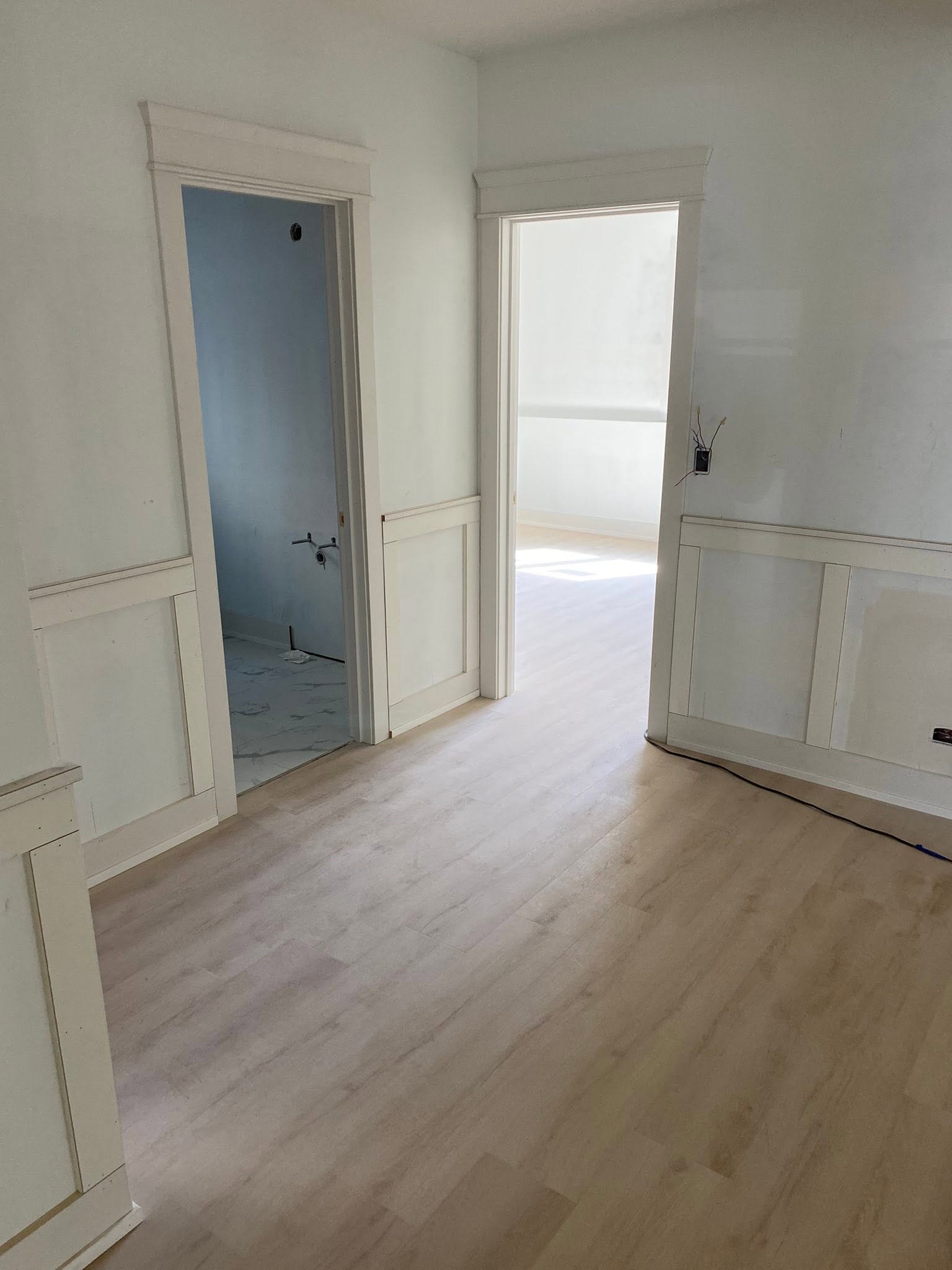 Luxury vinyl plank flooring installed through a hallway