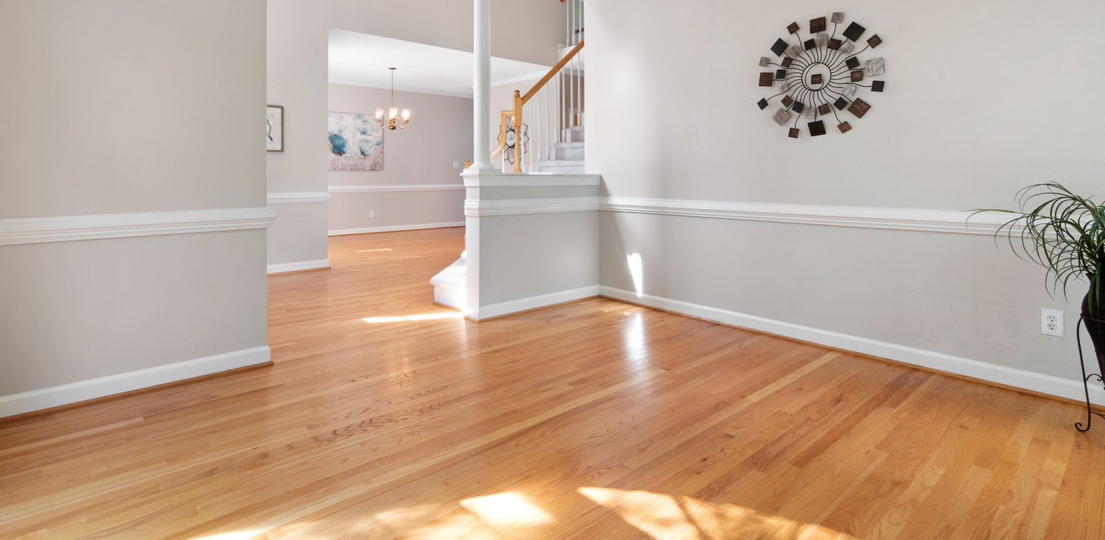 Elegant great room with glossy hardwood flooring and a stairway overlook